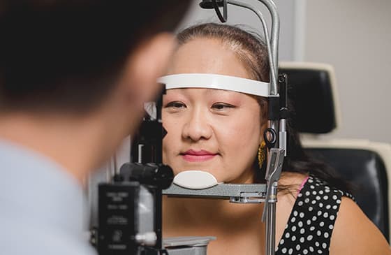 Woman getting a contact lens exam