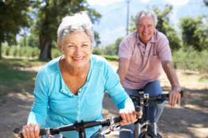 older couple riding bikes no glasses